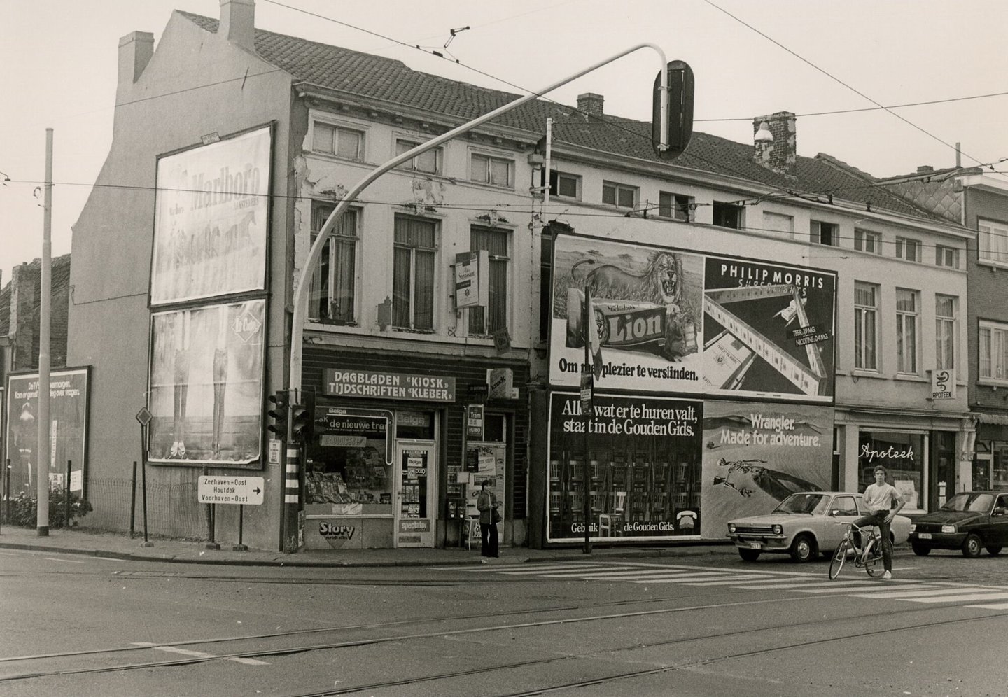 Straatbeeld met gevels en etalage dagbladhandel en apotheek in Gent